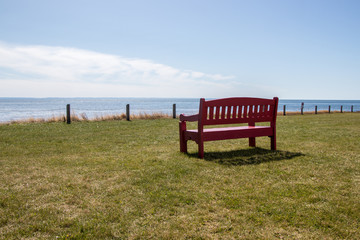 a red park bench at Point Prim Light House Museum in PEI