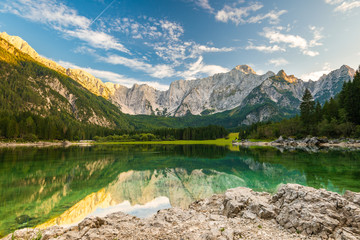 Beautiful Day at Fusine Lake in Italy. Forest and Mountains Reflection in Emerald Lake Water
