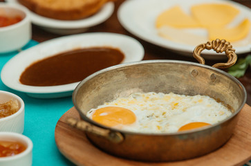 close up of sunny side up eggs in turkish copper pans for breakfast