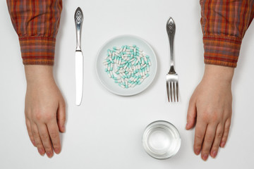 Supplementary food on the dish with fork and spoon