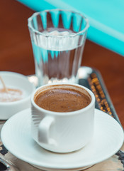 close up of turkish coffee served with cold water