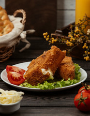 close up of crispy fried chicken nuggets with melted cheese inside