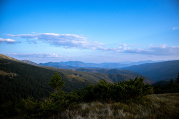 View of mountains. Blue sky with hills.