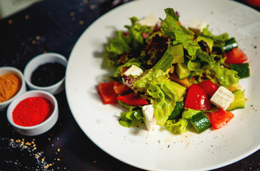 fresh lettuce salad with cucumber, tomato and white cheese