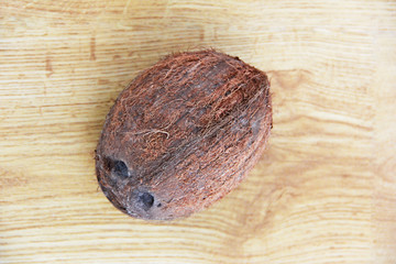 natural brown hard coconut fruit on wooden background