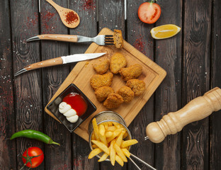 top view chicken nuggets served with french fries, mayonnaise and ketchup mix