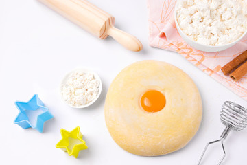 Ingredients for baking. Eggs, cottage cheese, dough on a light background. Homemade food. Copy space