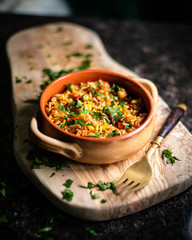A bowl of paella in wood