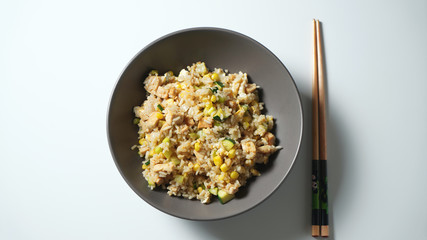 Rice in a plate. Rice with chicken, corn and zucchini. Asian style.
