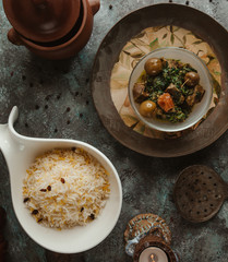 top view of pilaf rice with meat with herbs in vintage plate