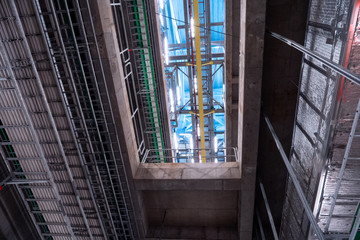 Obraz premium View of the plant from the outside, pipes smoke, wind turbines in the sea, barrels, tanks, thermal power plant, modern, technological waste processing plant, garbage processing plant