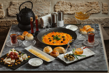 traditional azerbaijani breakfast with egg and tomato dish, tea, honey, butter