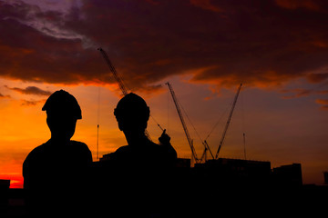 silhouette of engineer building construction at sunset