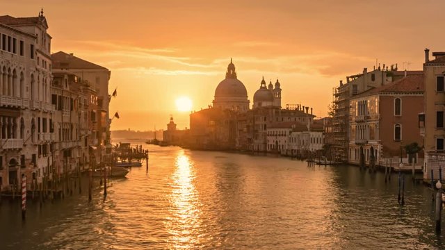 Sunrise hyper lapse of Grand Canal traffic and Basilica di Santa Maria della Salute, view from Accademia bridge, Venice, Italy