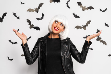 attractive woman in white wig with outstretched hands in Halloween