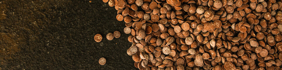chocolate drops (black or milk chocolate, sweet ingredient) menu concept. food background. copy space. Top view