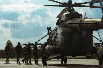 Fototapeta na wymiar Special forces loaded in a helicopter at the airport