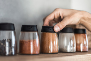 close up. a man chooses spices in the kitchen