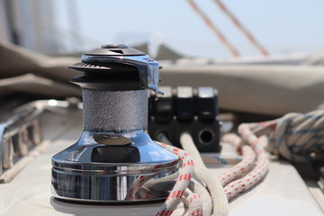 A winch on a sailing yacht for pulling up files and sheets against the background of the summer...