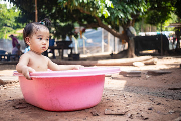 Little kid sitting in a bath tub outdoor