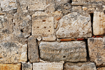 The rough masonry of large blocks of an ancient structure, like a texture of a stone wall of large blocks.