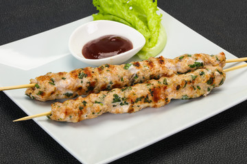 Minced pork skewer kebab with sauce