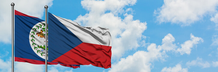 Belize and Czech Republic flag waving in the wind against white cloudy blue sky together. Diplomacy concept, international relations.