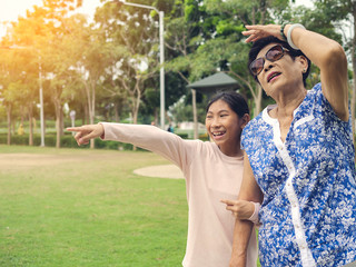 Asian senior woman walking in the park her grandchild, lifestyle concept.