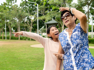 Asian senior woman walking in the park her grandchild, lifestyle concept.