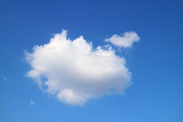 Naklejka na ściany i meble White fluffy cumulus clouds in the blue sky