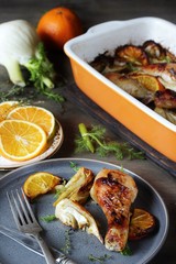 dish with fennel. Baked chicken drumsticks with fennel and oranges. festive dish, popular in the Mediterranean. Keto diet dish. ceramic baking dish.