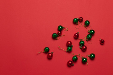 Multicolored classic christmas little balls on red background