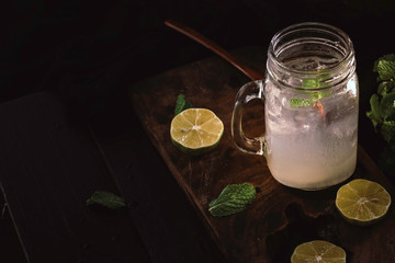 Lemon juice. Lemon juice in a glass. Place on a dark wooden floor. leaving space for text