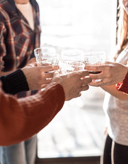 background image of a glass of juice in the hands of the young couple