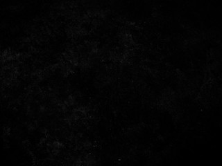 Black speckled grunge texture as background for designs.