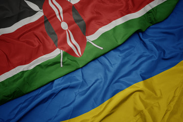 waving colorful flag of ukraine and national flag of kenya.