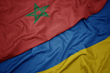 waving colorful flag of ukraine and national flag of morocco.