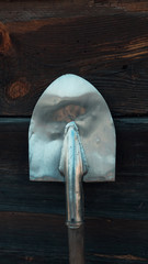 Old rusty shovel prop up against Old wooden wall, Wooden texture background