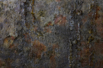 Texture. Fragment of the wall of an old wet basement covered with spots of rust and drops of tar....