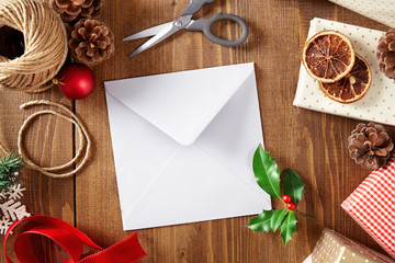Christmas letter with copy space on a wooden background viewed from above. Top view. Christmas greeting card