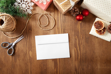 Christmas letter with copy space on a wooden background viewed from above. Top view. Christmas greeting card