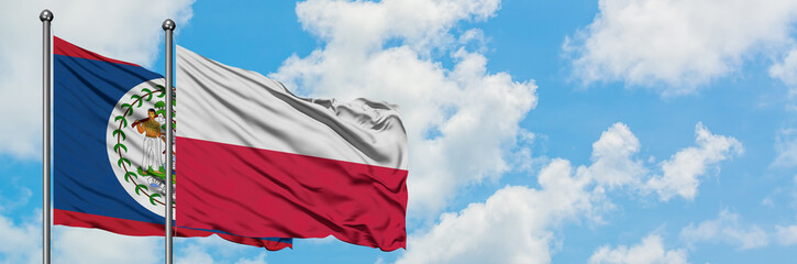 Belize and Poland flag waving in the wind against white cloudy blue sky together. Diplomacy concept, international relations.