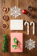 Christmas presents and decoration flat lay on a wooden background viewed from above. Top view