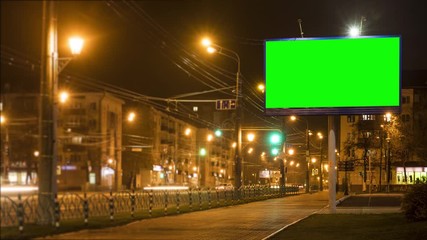 billboard stands by road against city buildings