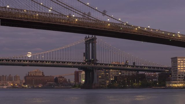 Moon rise time-lapse form East river with Manhattan And Brooklyn bridge day to night .