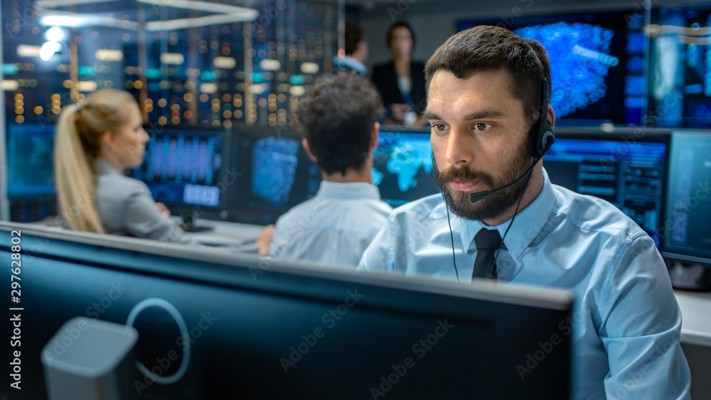 Poster customer service representative answer client's questions in a headset. he works for a big technolog