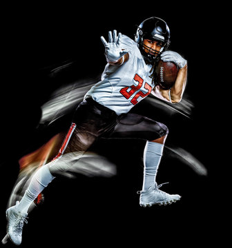 one african american football player man studio shot isolated on black background with light painting with blurred motion speed effect