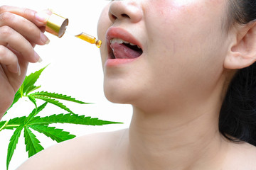 Woman holding a dropper sublingual Cannabis oil at leaf and white background