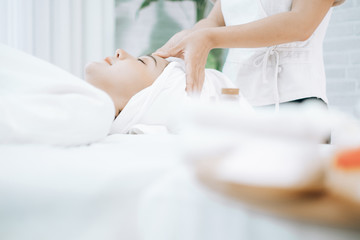 Beautiful young woman lying down on beds massage and spa at asian spa massage and beauty salon center, spa concept, massage concept
