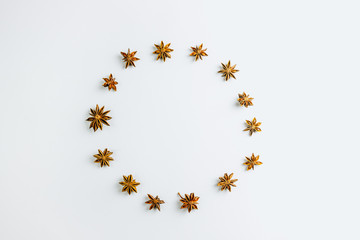 Christmas composition. Wreath made of anise stars on white background. Christmas, winter, new year concept. Flat lay, copy space Christmas minimal concept.